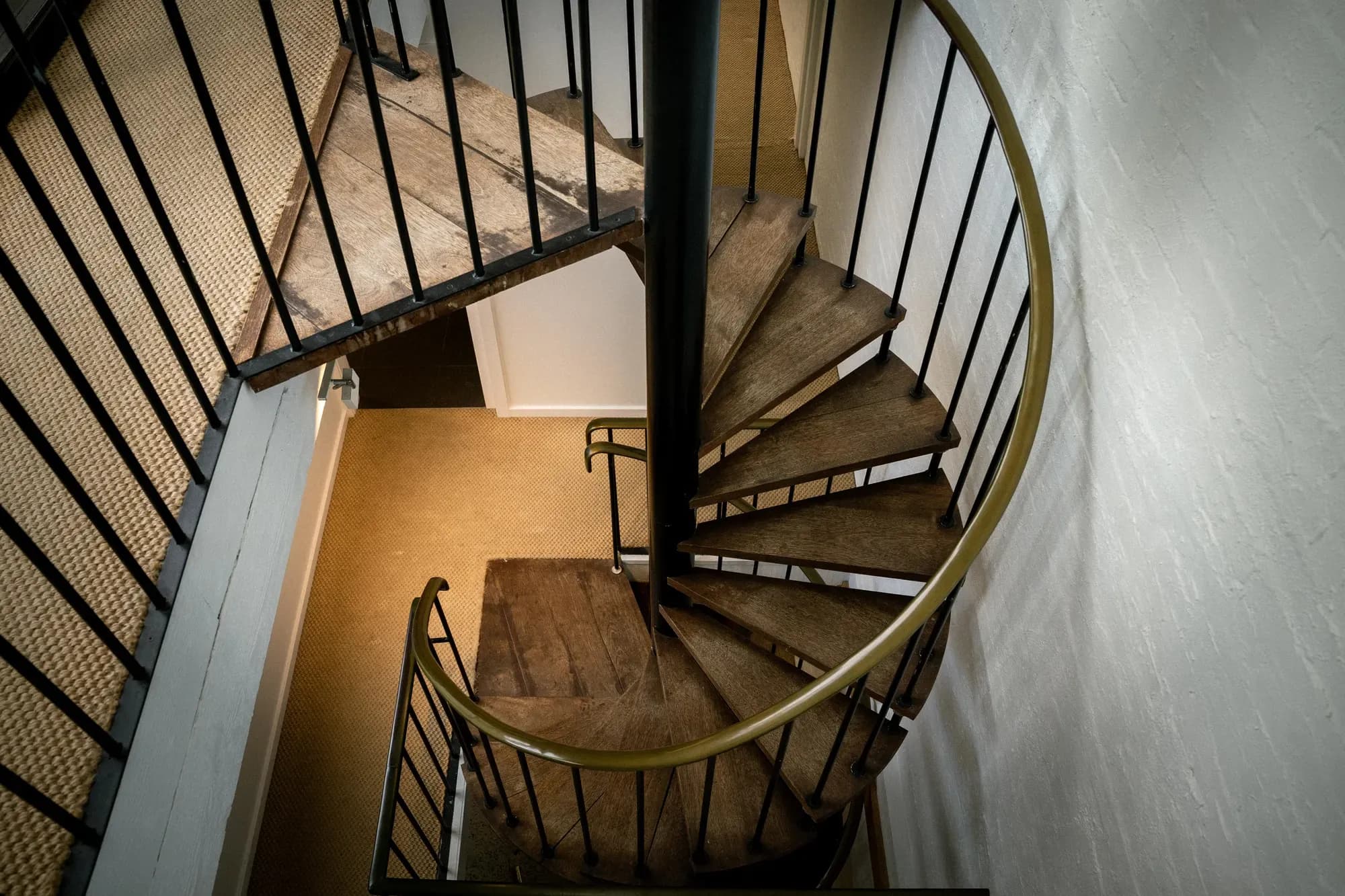 The spiral stair seen from the landing above