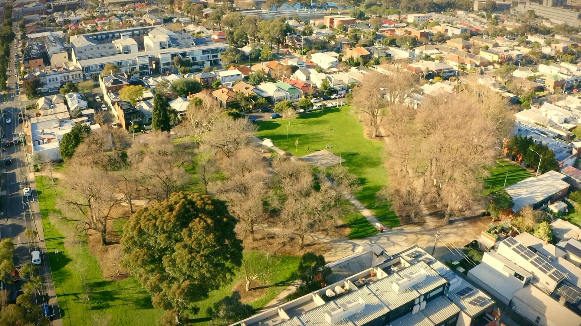 Melbourne’s Northside from the air: a park ringed by rooftops and tree-lined streets