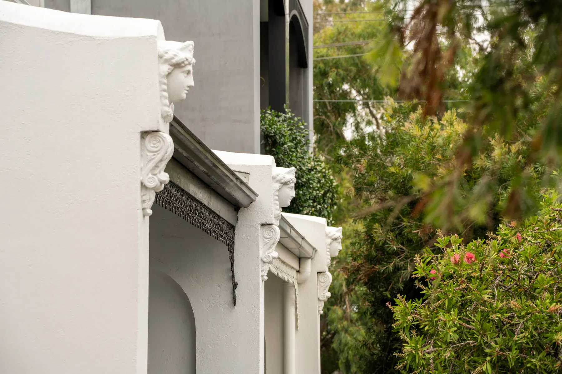 A rendered period facade behind a garden on Melbourne’s Northside