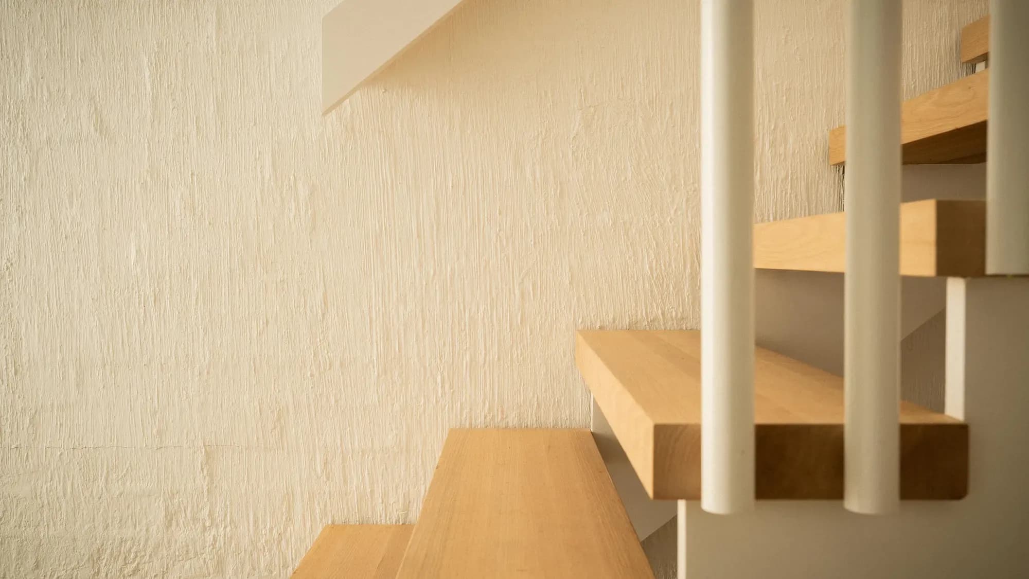 The stair turning against a cream wall