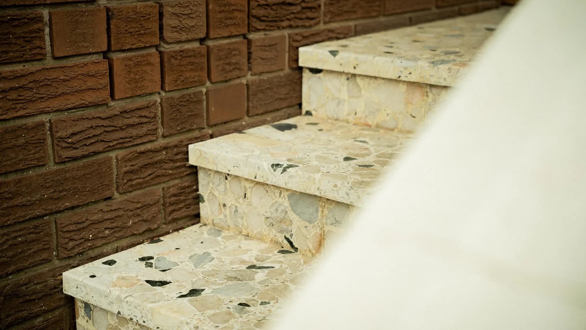 Terrazzo steps set against brown brick